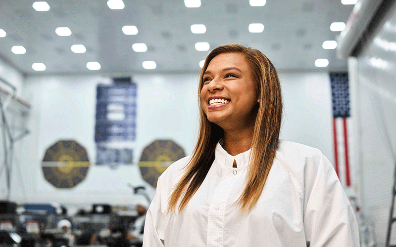 woman smiling wearing clean suit