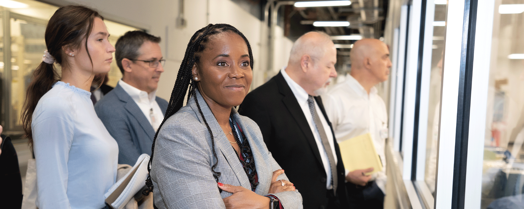 people standing looking through a window