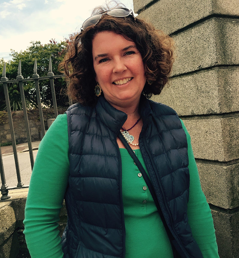 women posing in front of fence