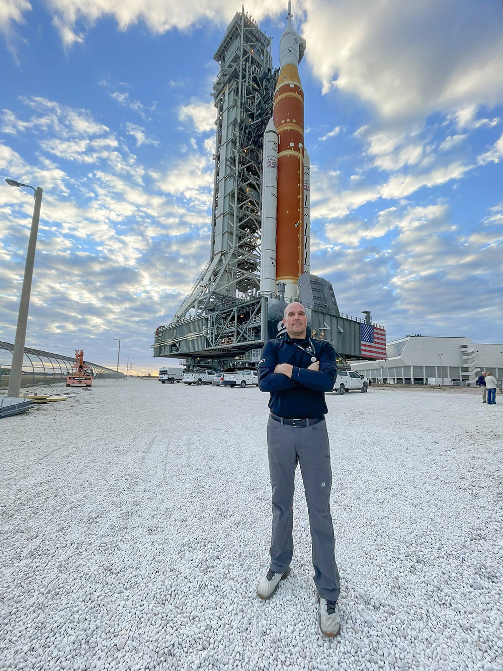 man standing in front of Artemis II rocket