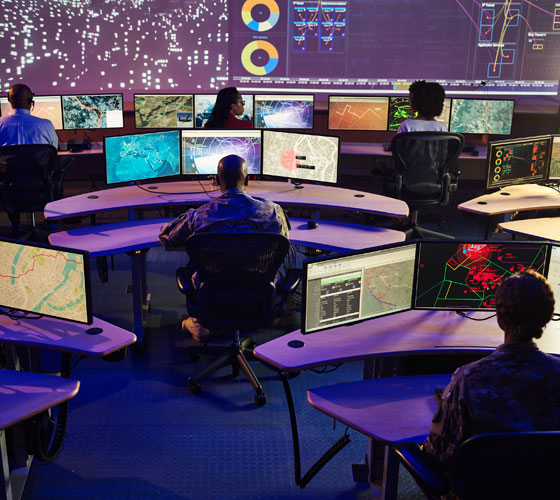 rendering of people working in a technology control room