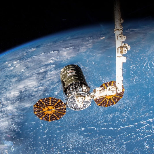 spacecraft with UltraFlex Array above earth
