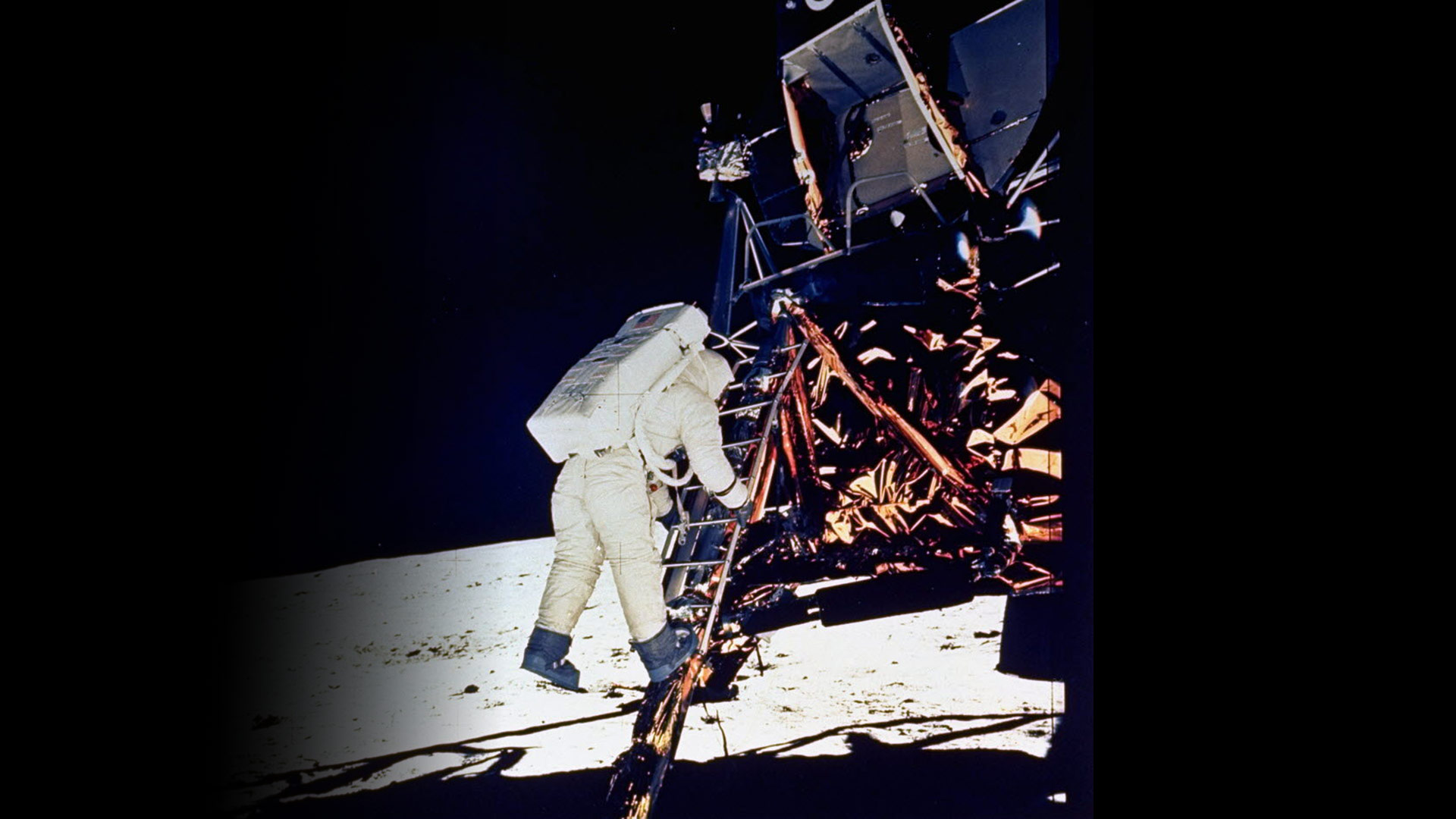 Astronaut stepping off Lunar Module onto the Moon