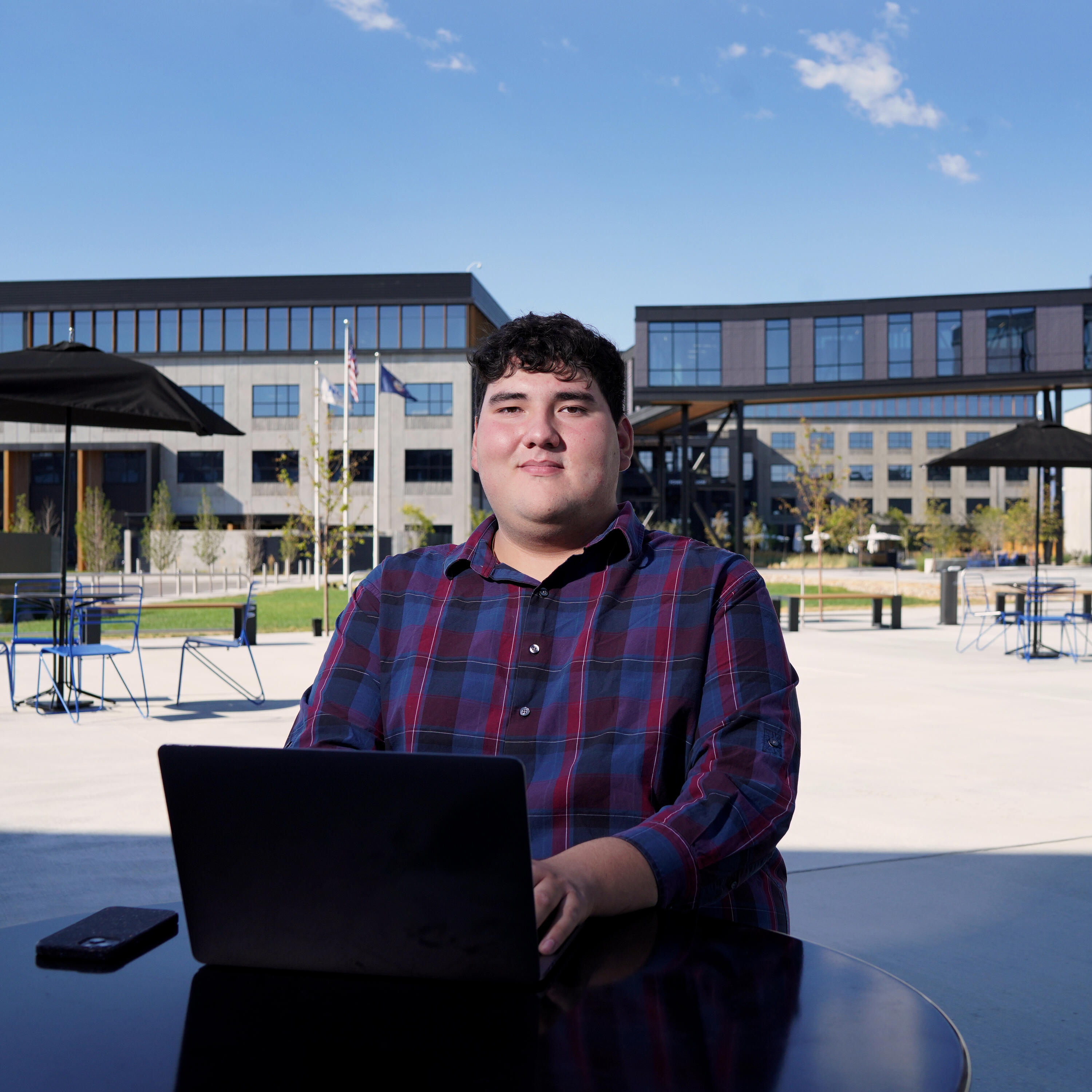 man on a laptop sitting on a chair