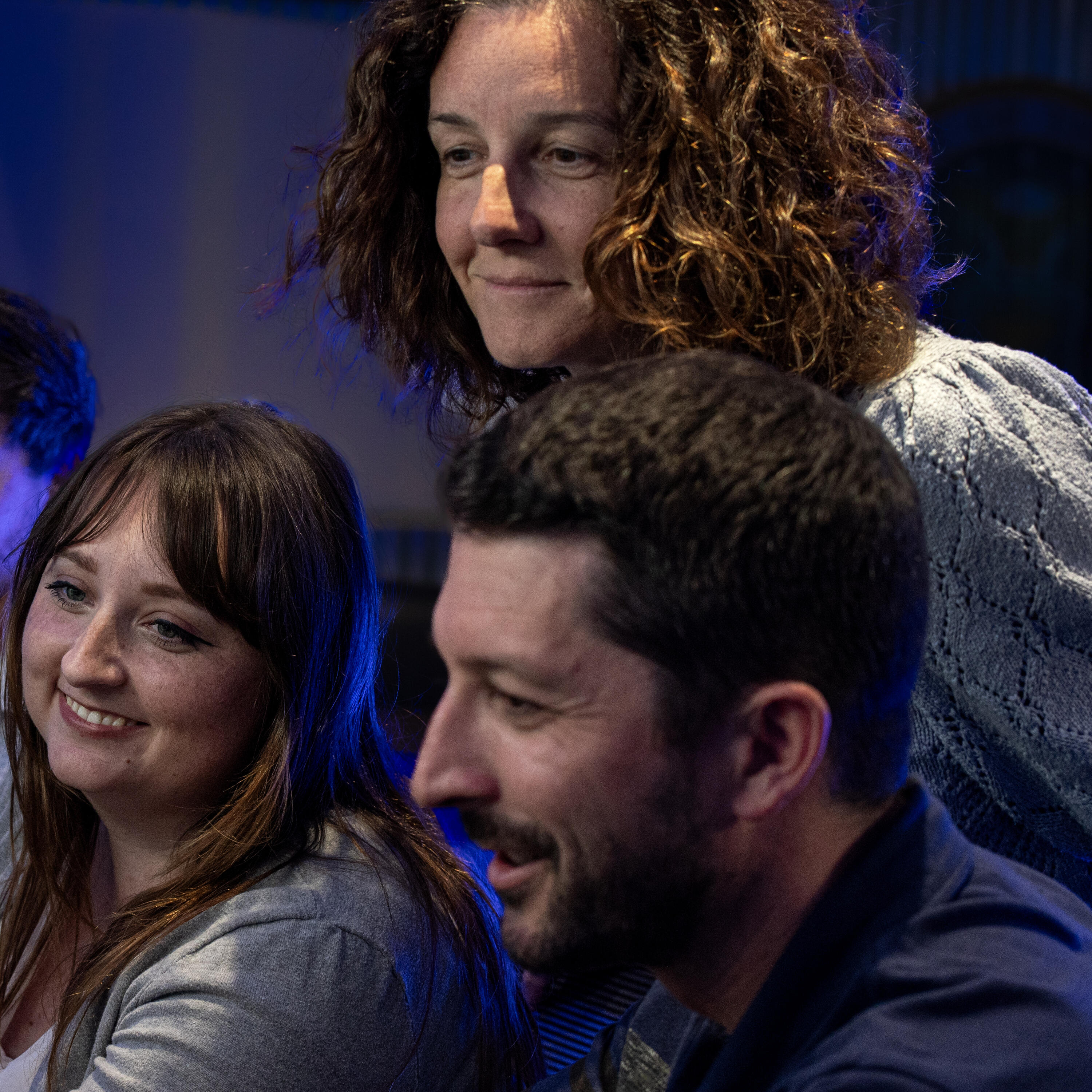 three people looking at a screen