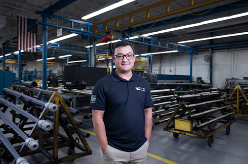 man smiling in manufacturing facility