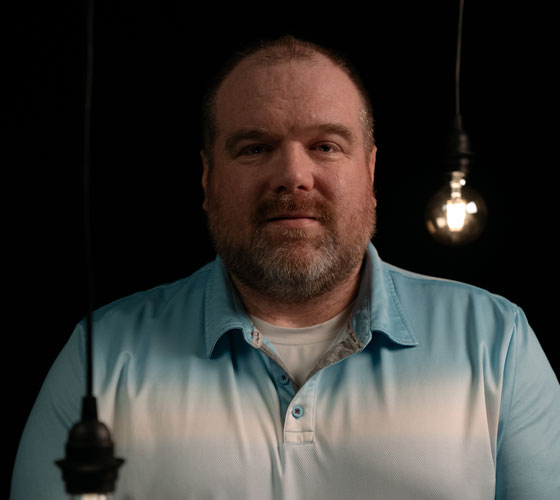 Man smiling on black background
