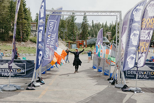 hiker crossing finish line in race