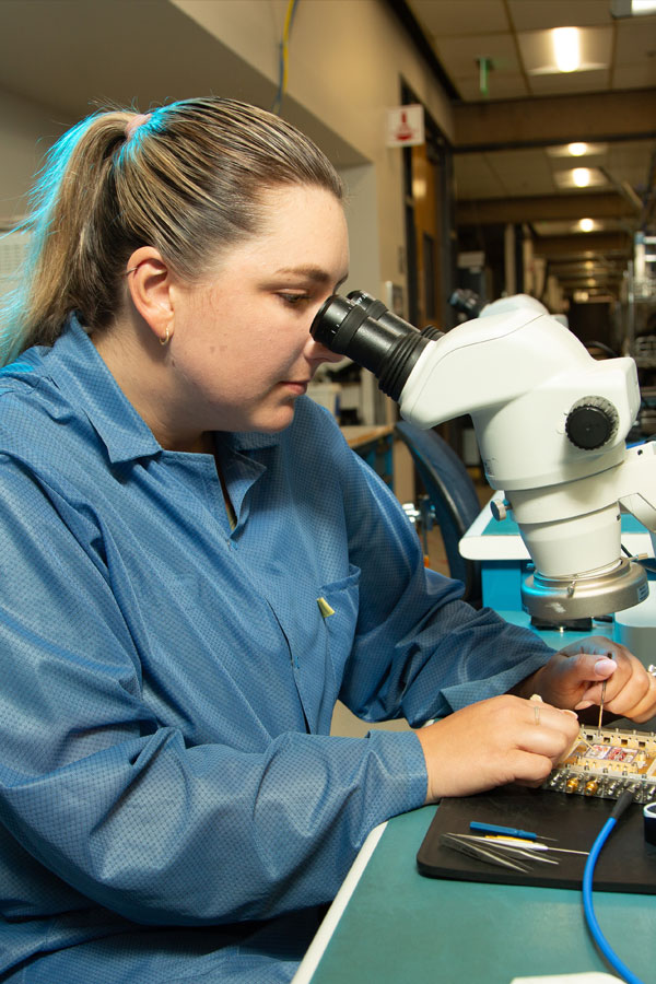 Scientist uses microscope in lab. 