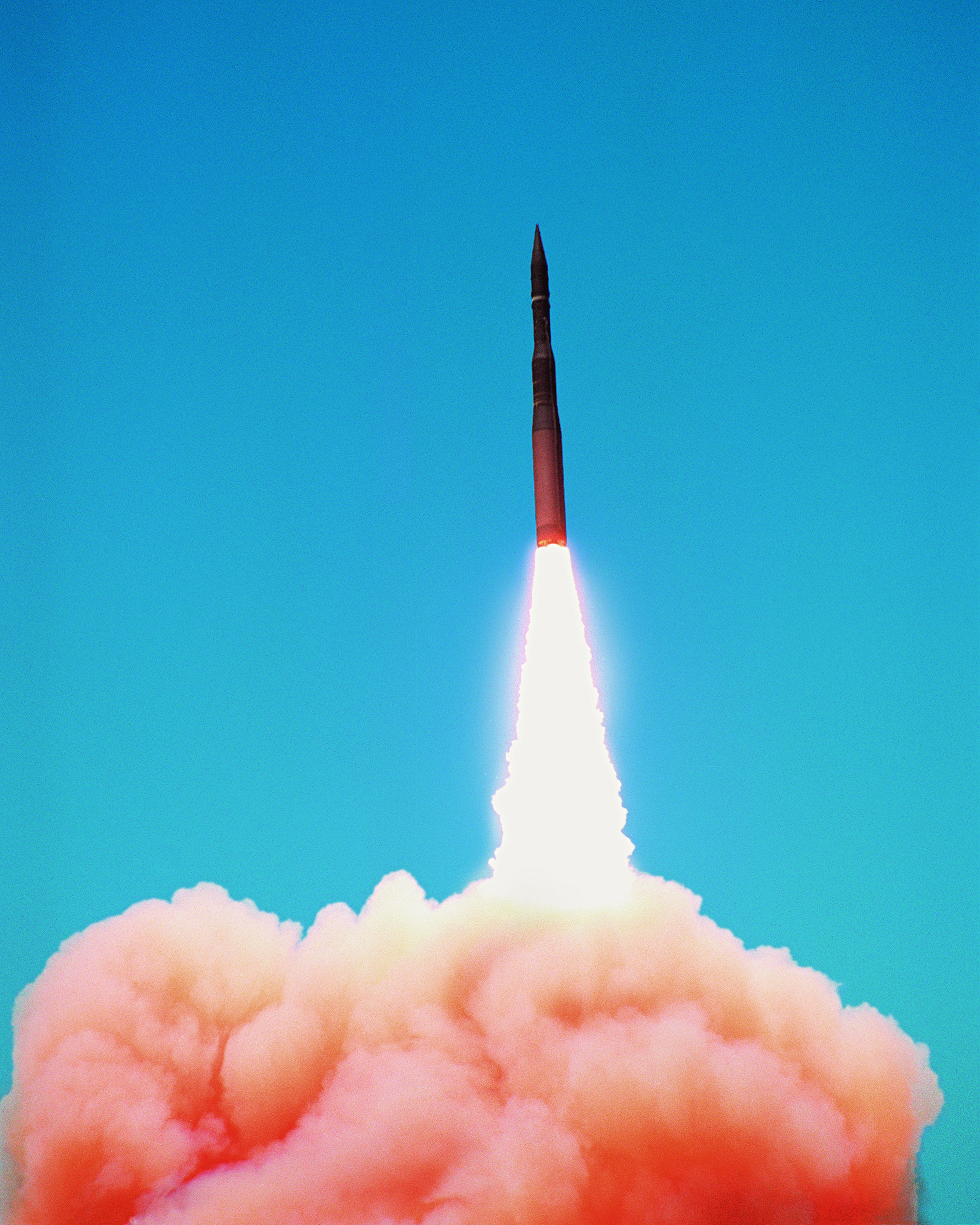 rocket launching in front of blue sky