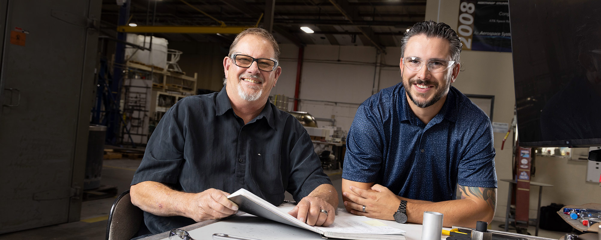 two men at drafting table