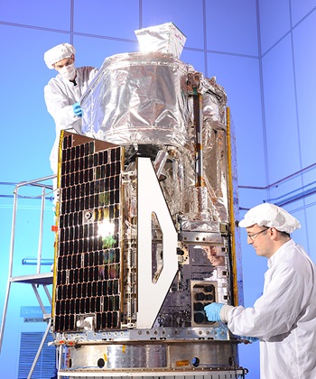 technicians working on satellite in high bay