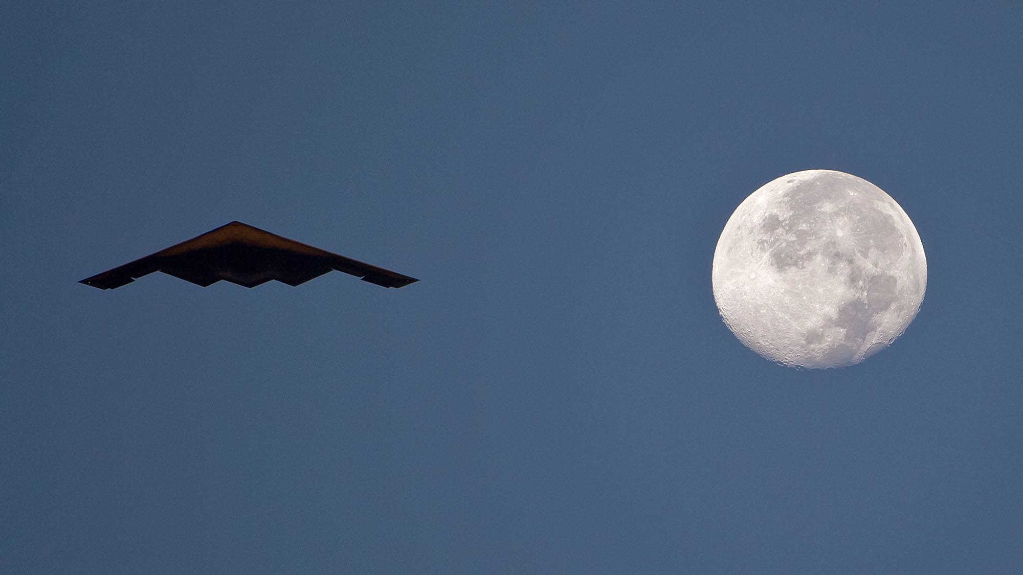 B-2 Spirit Stealth Bomber 110816pmar490004 B-2 Spirit Stealth Bomber flying with full moon in sky