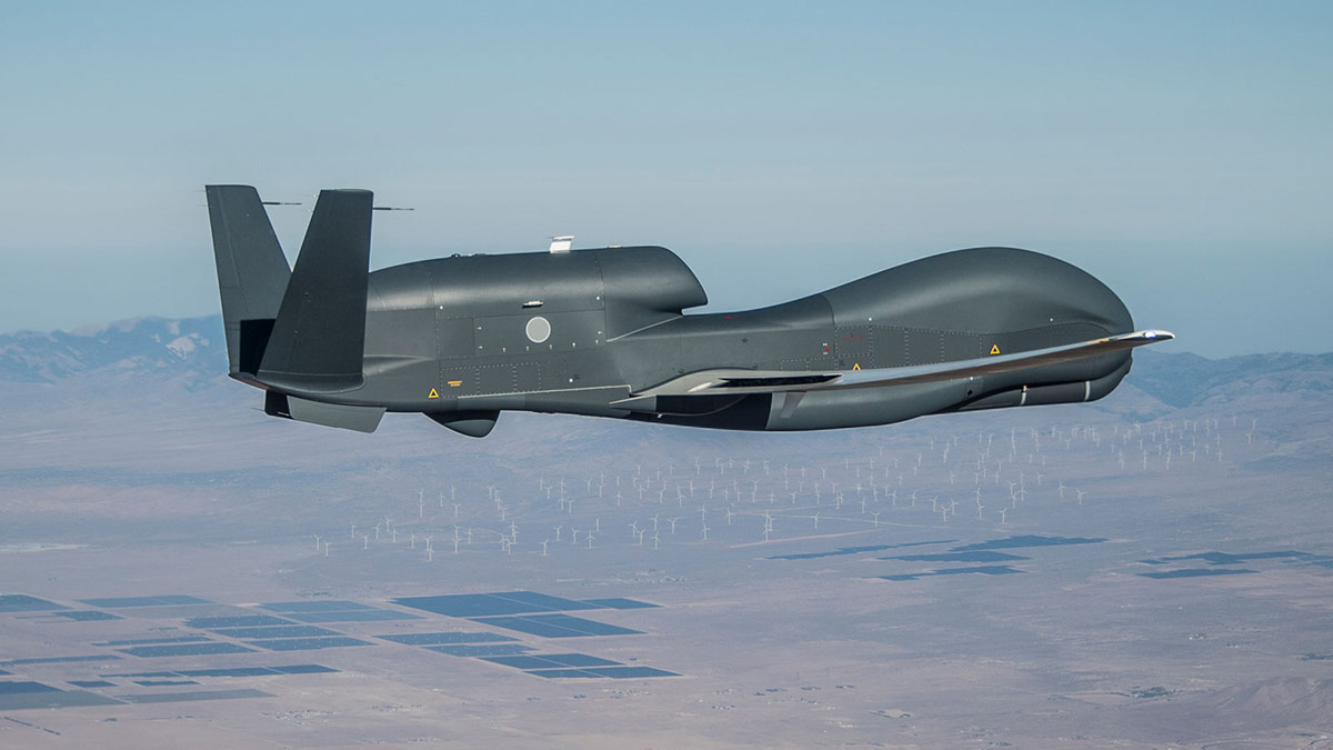 Global Hawk unmanned aircraft flying above mountains