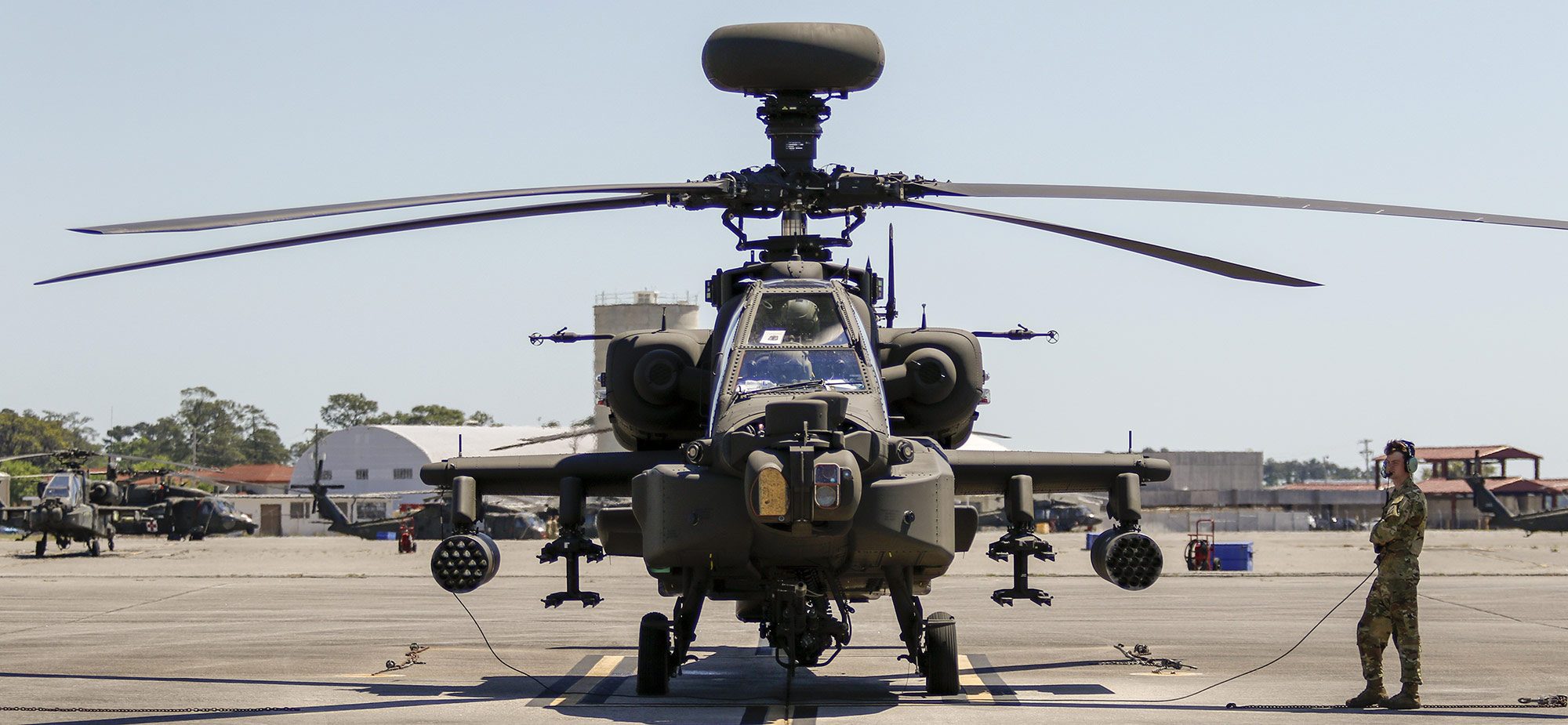 ah-64e apache helicopter sits on flight line 