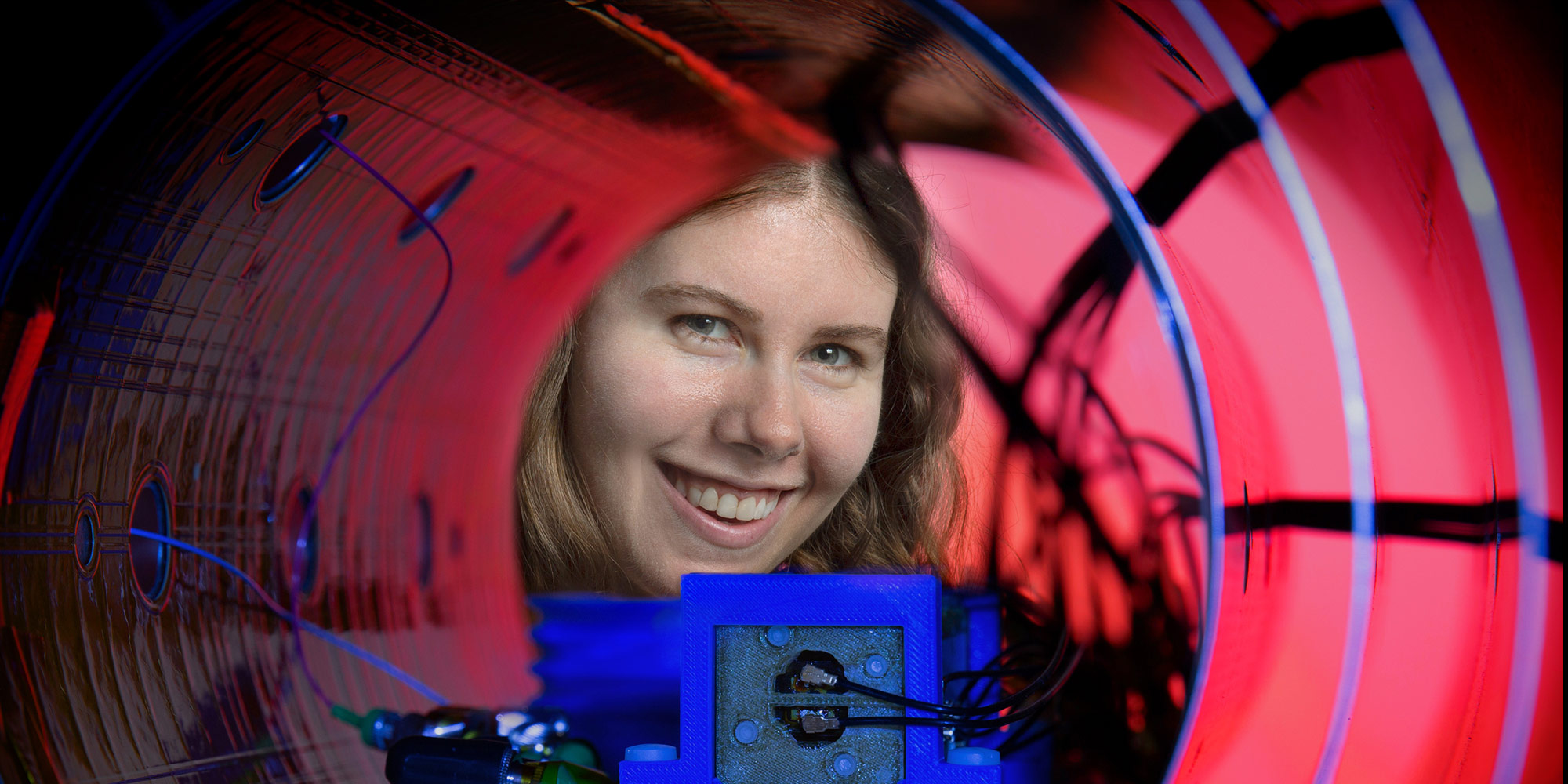 Quantum Magnetometers women looking through instrument that measures magnetic fields