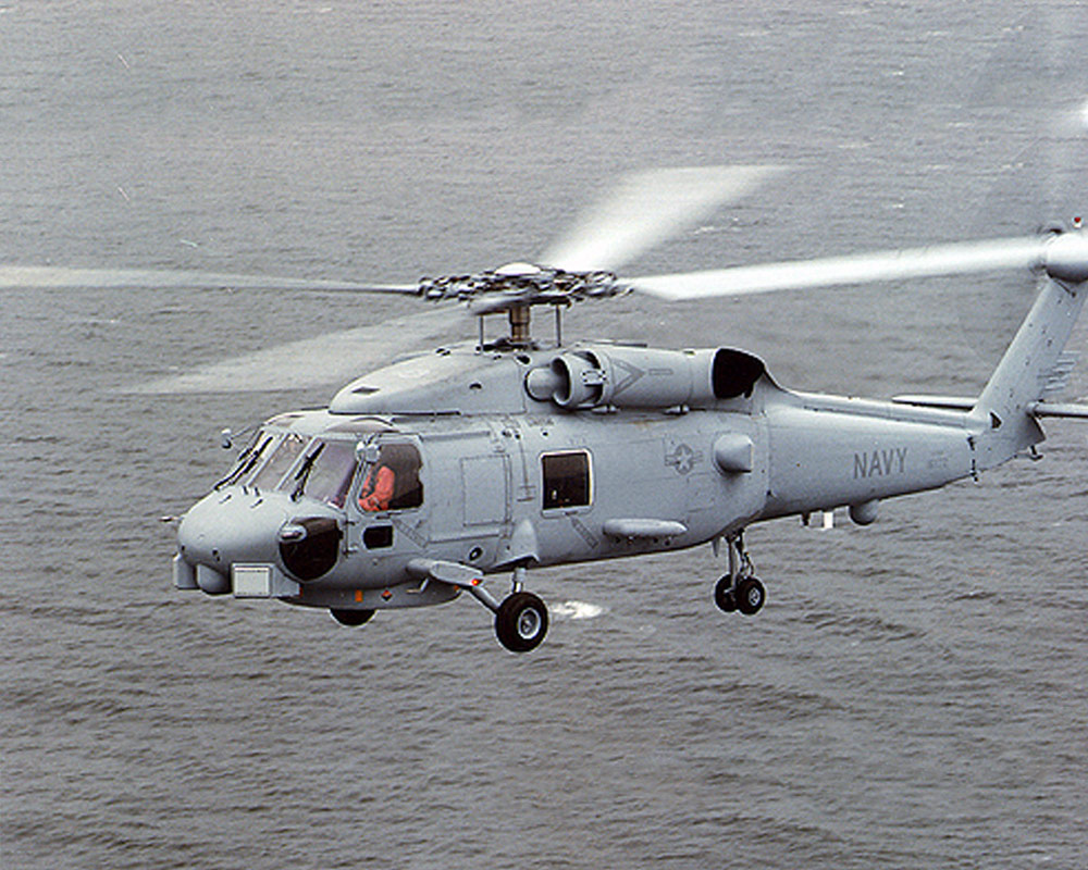 A left side view of an SH-60 Seahawk Light Airborne Multi-purpose System (LAMPS III) helicopter in flight LN-100G Embedded INS/GPS (EGI)