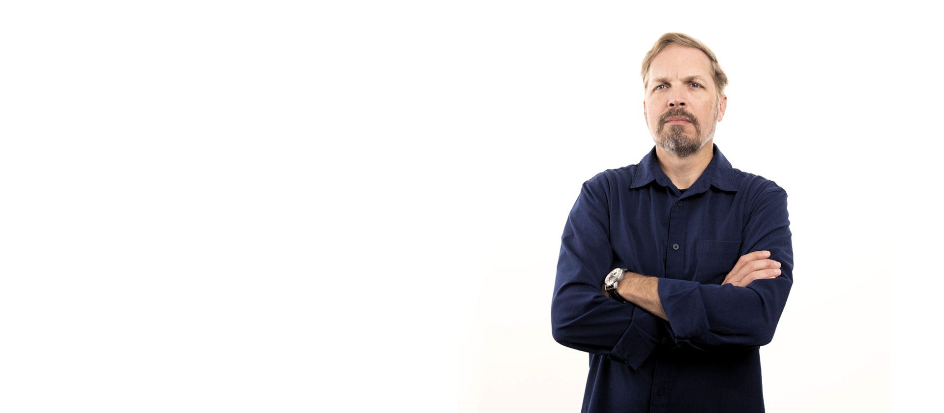 Man with crossed arms on white background