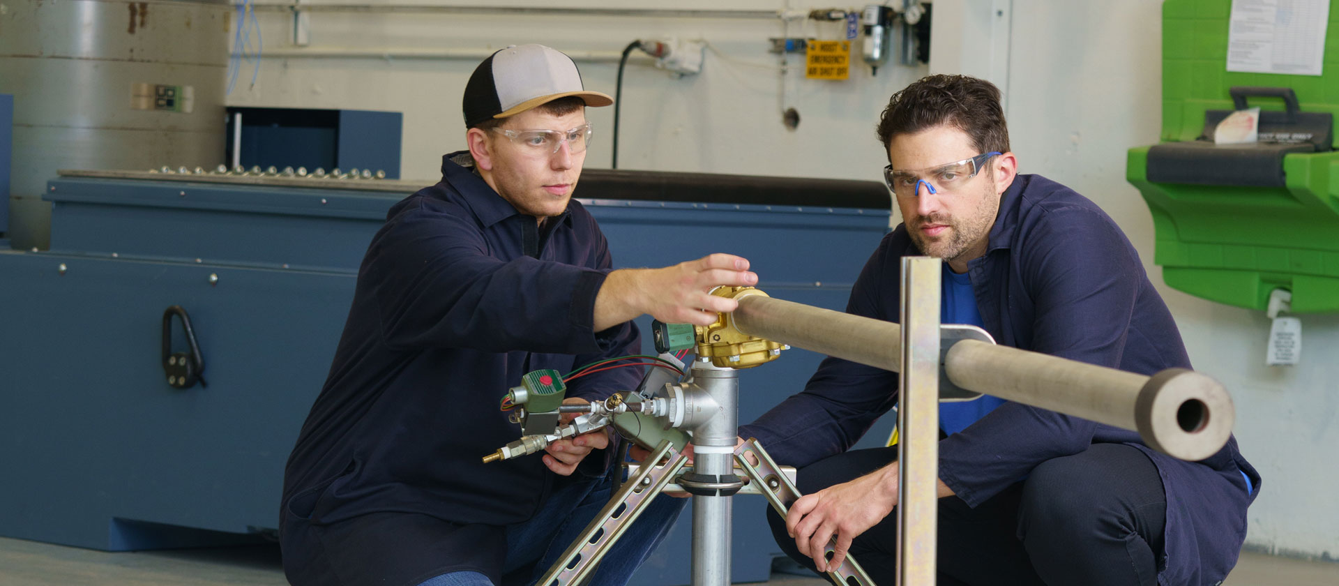 Two rocket motor engineers looking at machinery.