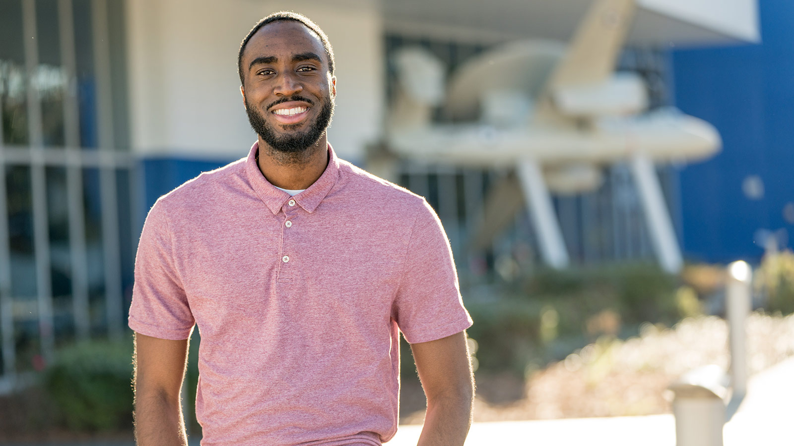An Engineer’s Journey: From BEYA to a Career at Northrop Grumma smiling Black man in pink polo shirt