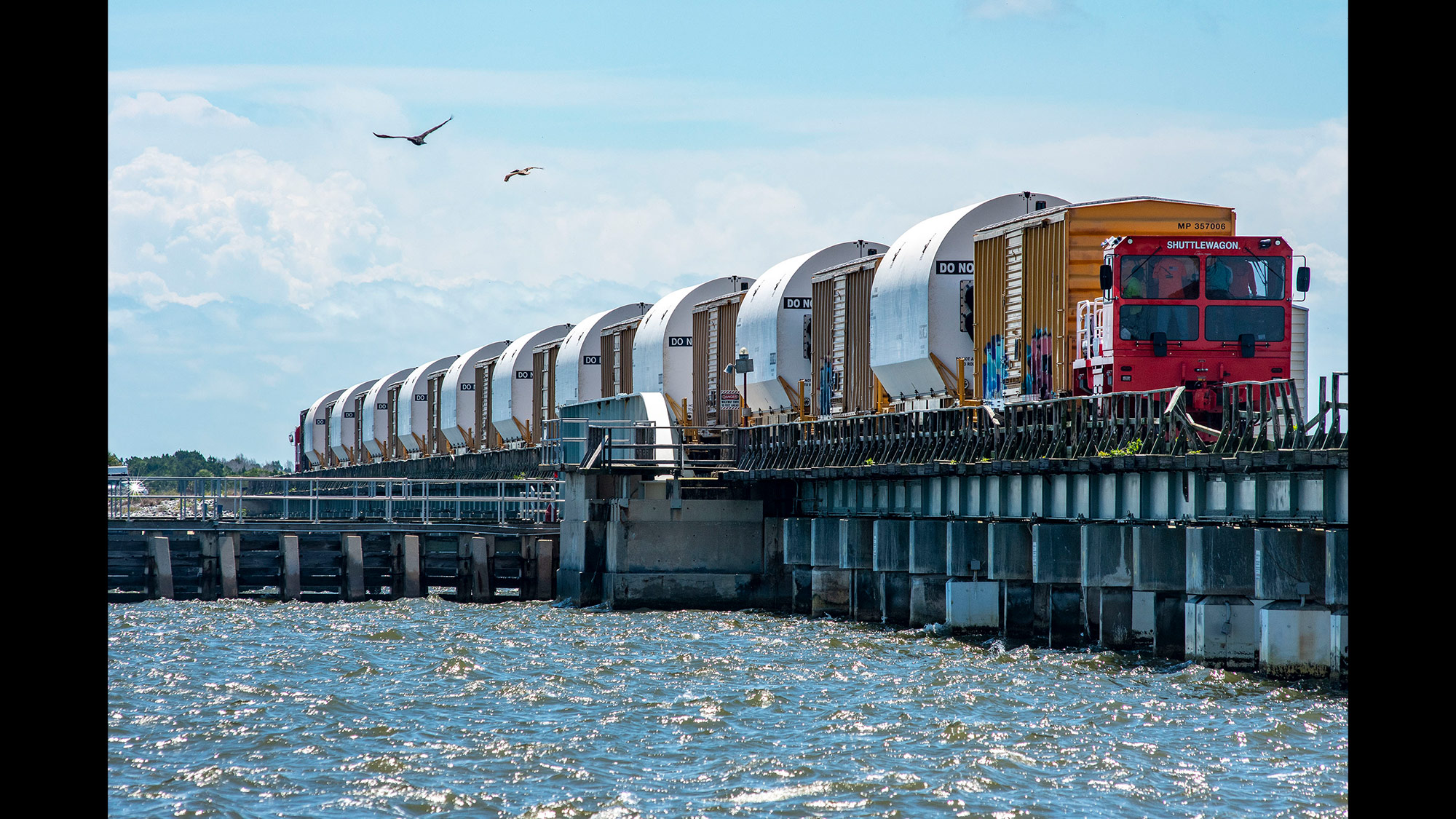 Artemis I Space Launch System rocket – slide Artemis I Space Launch System rocket on train over bridge