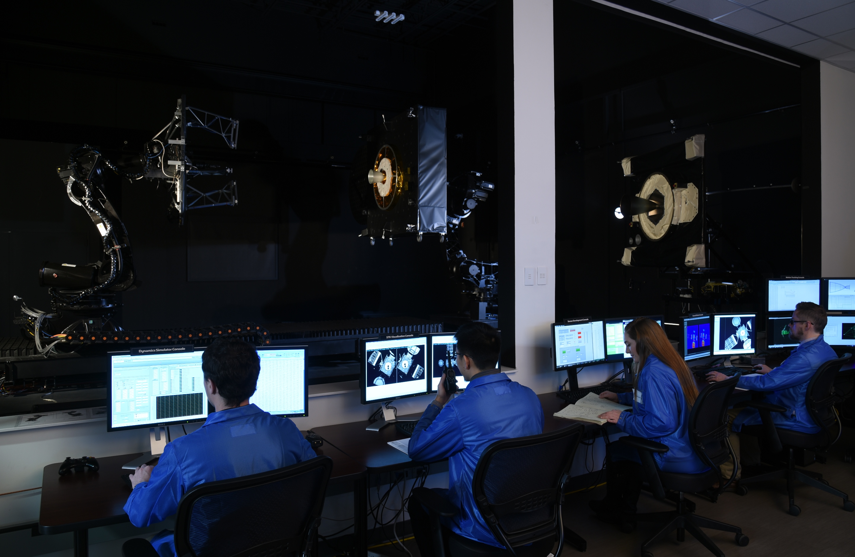 technicians at computers in Mission Extension Vehicle control room
