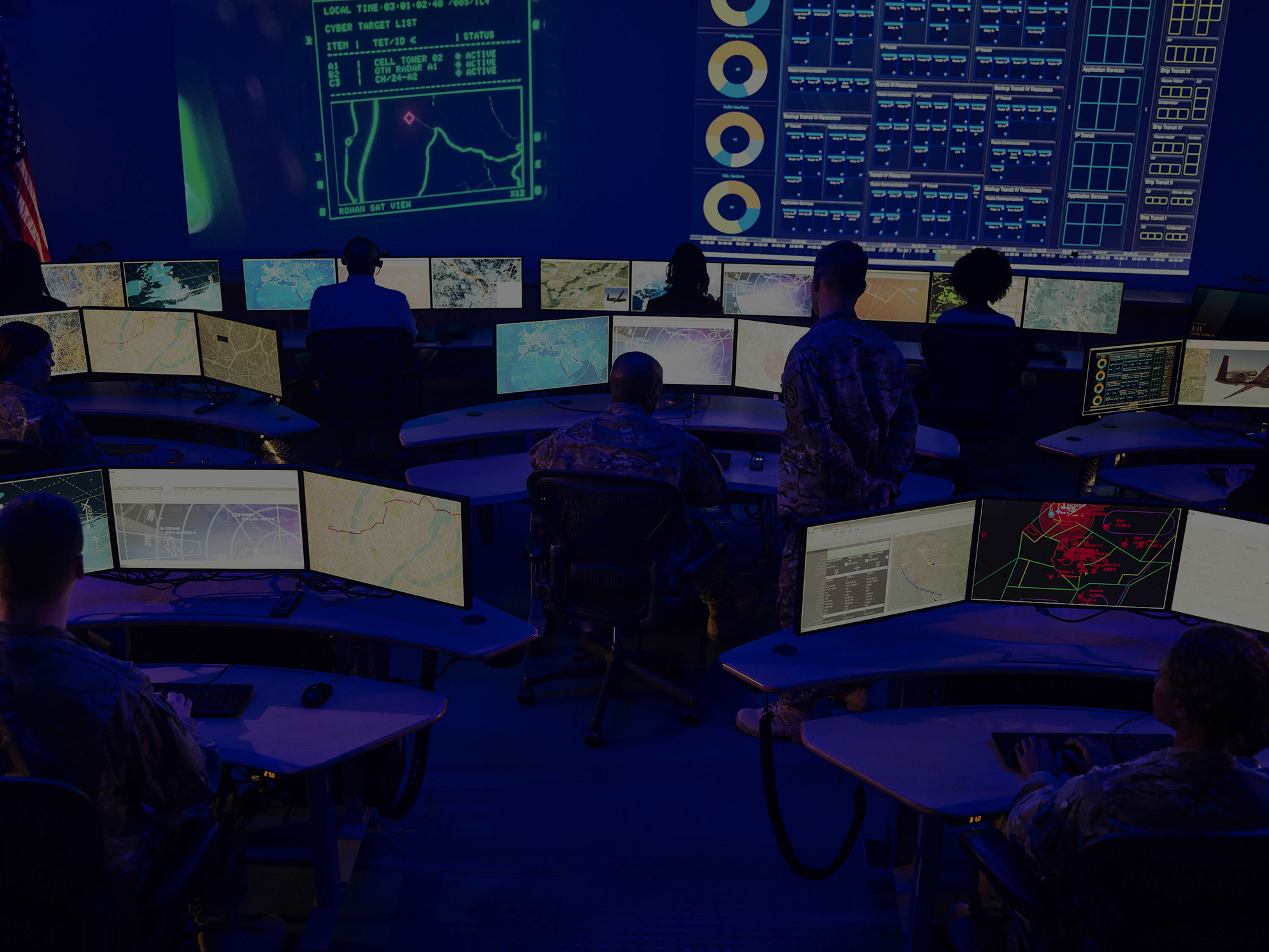 Cyber Control Room Northrop Grumman Large command center with multiple computer screens and people monitoring data.