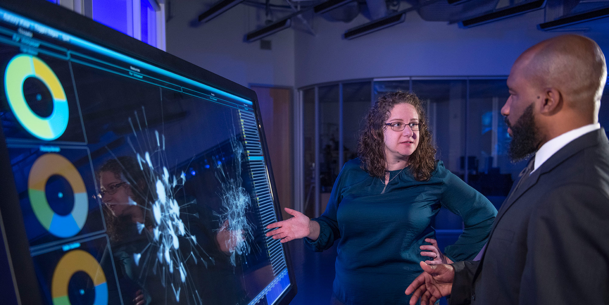 Digital-Engineering-Casey-Elliot-Kerron-Duncan-CIS-Center a white woman and black man in conversation in front of a computer