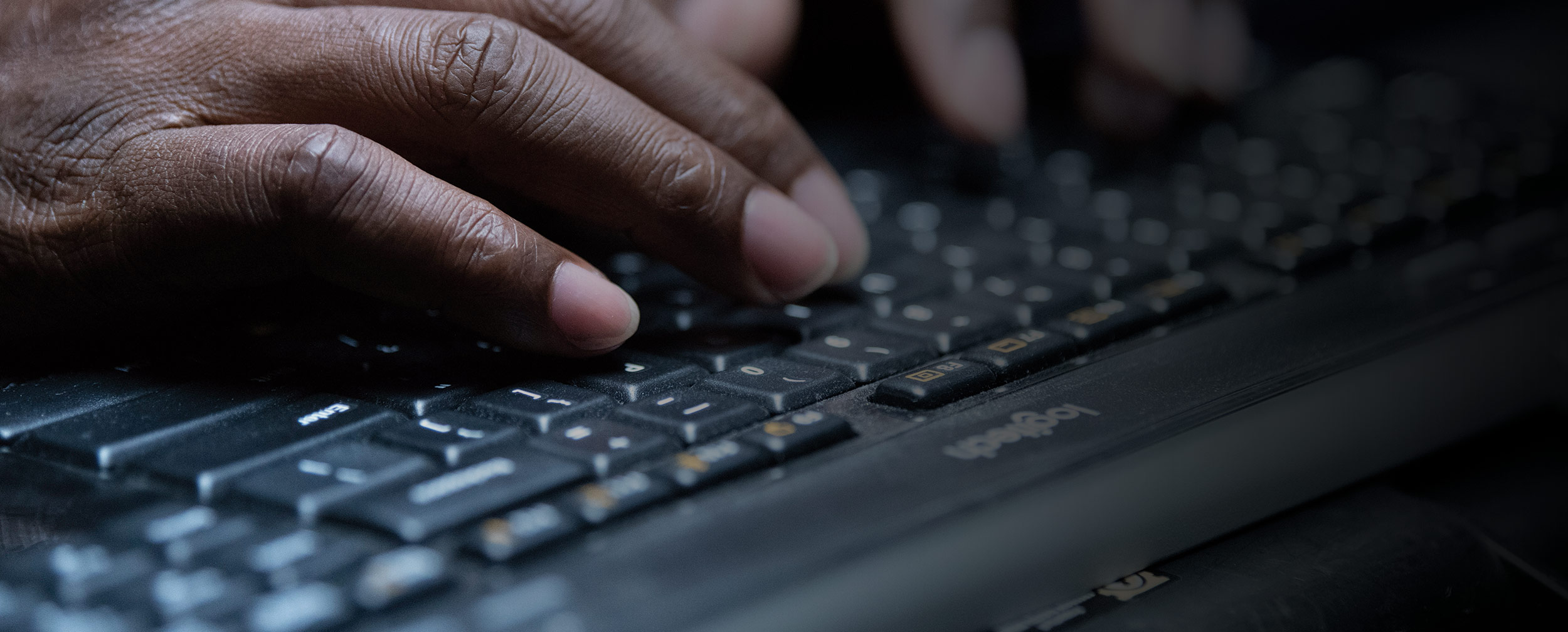 Ditching-Documents-hands-right2 hands typing on a keyboard with a black gradient on the right side for text overlay