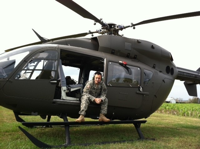 Man in military uniform sitting in open door of helicopter on ground_Rob military transition <strong>Transitioning from the Military to Northrop Grumman</strong>
