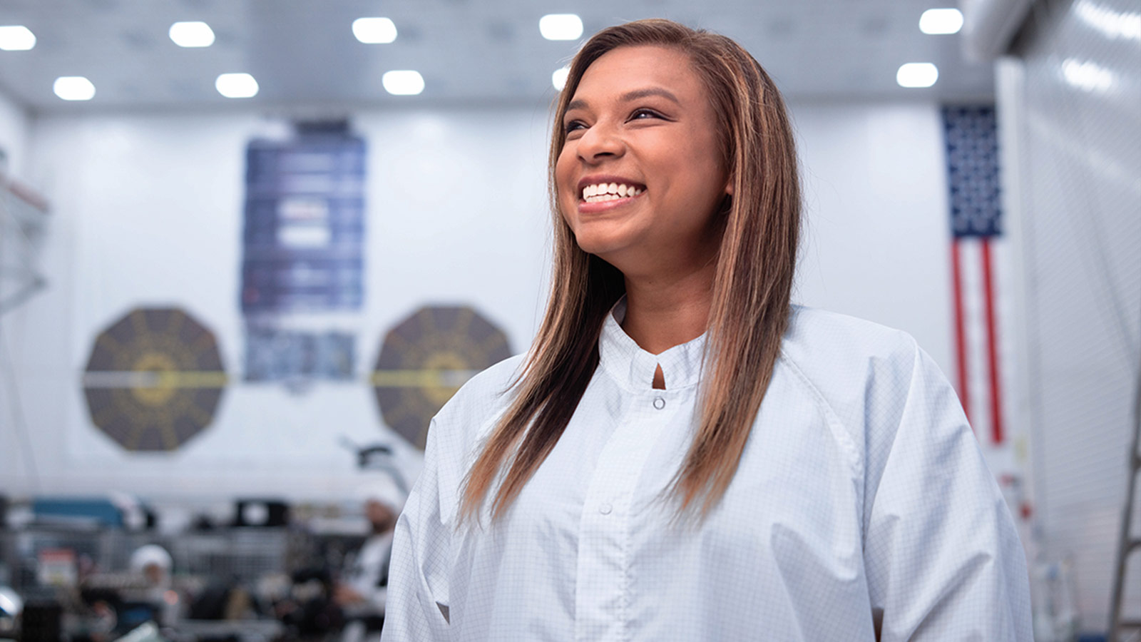 Made it Possible: Lisa and a Chorus of Support smiling Black woman in white clean room