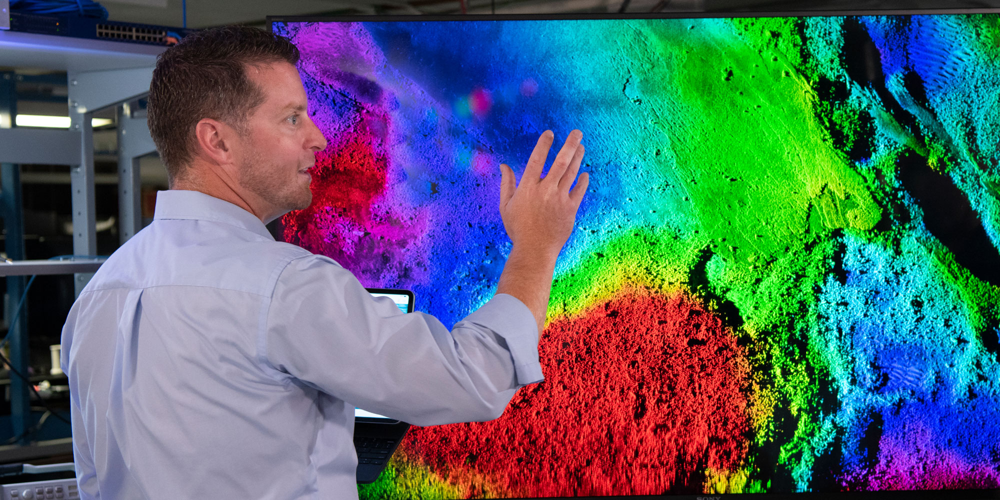 Man views imagery on large display