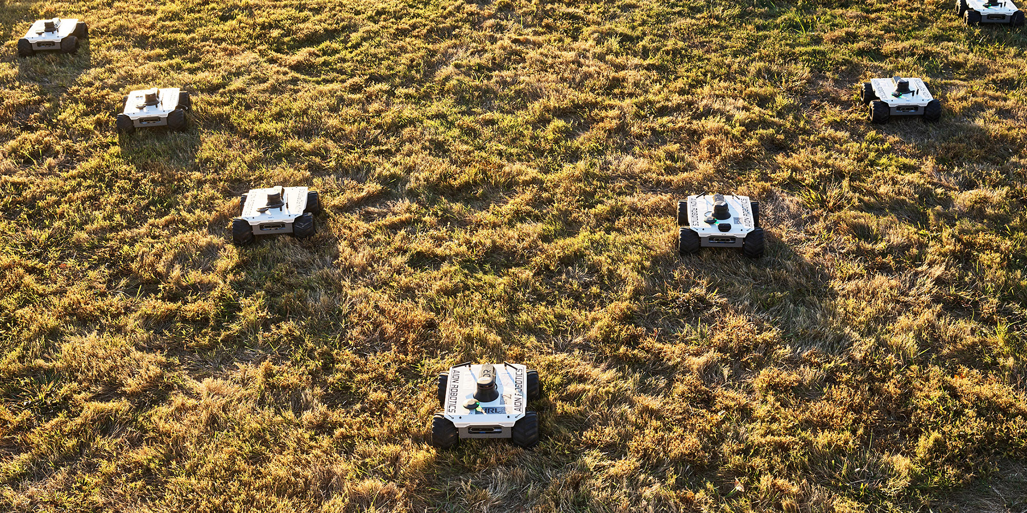 Artificial Intelligence and Machine Learning – hero several small autonomous robots on land