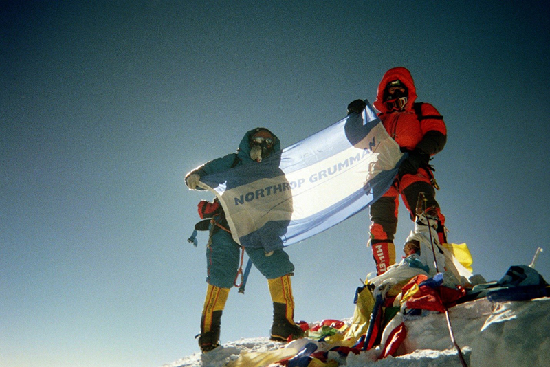 Northrop Grumman engineer summits Mt. Everest and displays the northrop grumman flag. <strong><strong>Engineer Summits Mt. Everest</strong></strong>